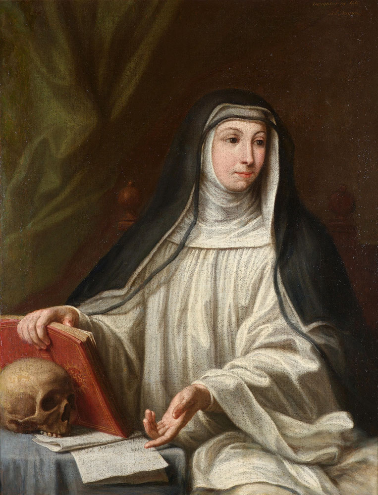 Mustavalkoiseen kaapuun pukeutunut nunna pöydän ääressä